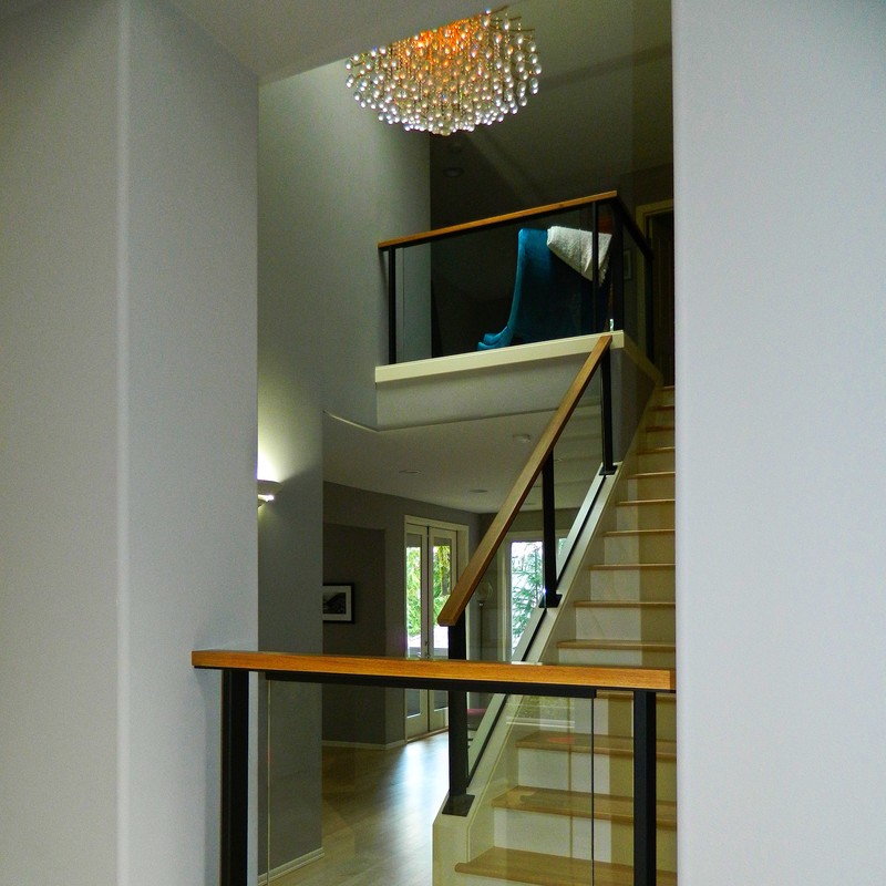 custom glass and metal railing with hickory handrail.